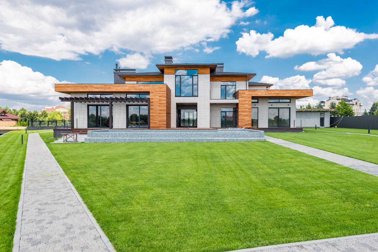 our-services-3 Stunning modern house exterior showcasing spacious lawn and contemporary architecture.